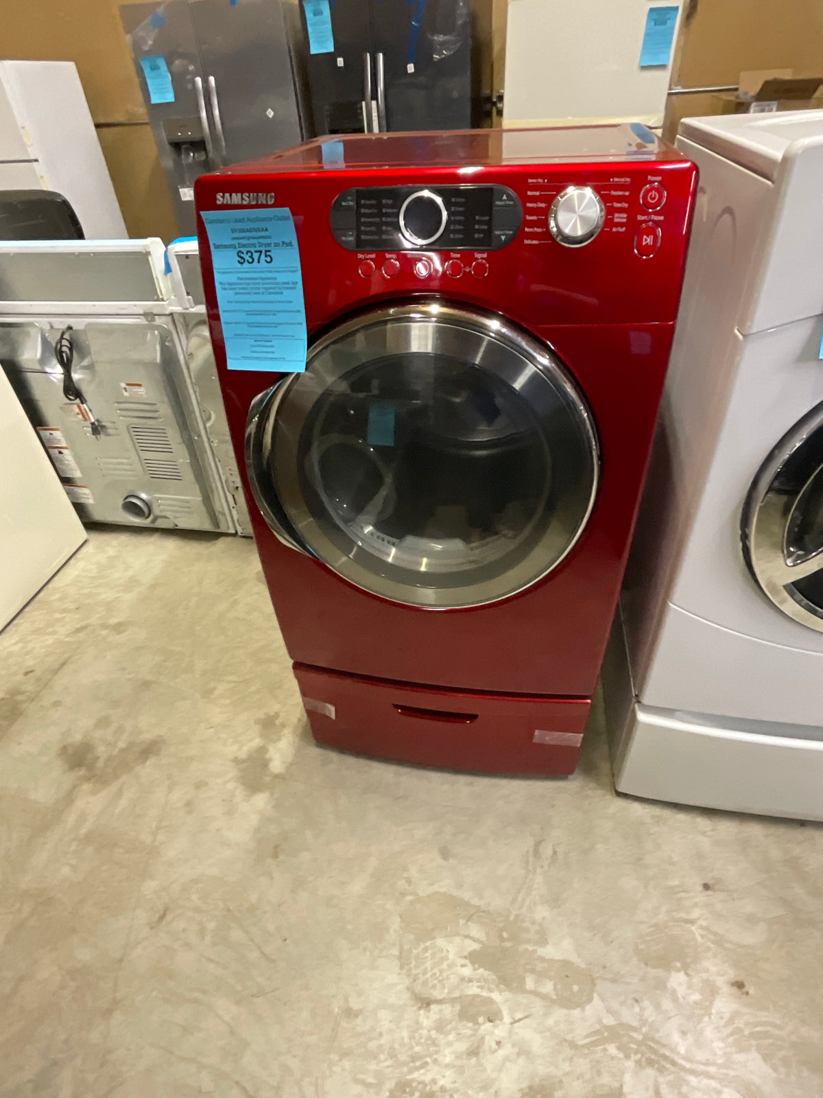 Red Samsung frontload Gas Dryer on a pedestal