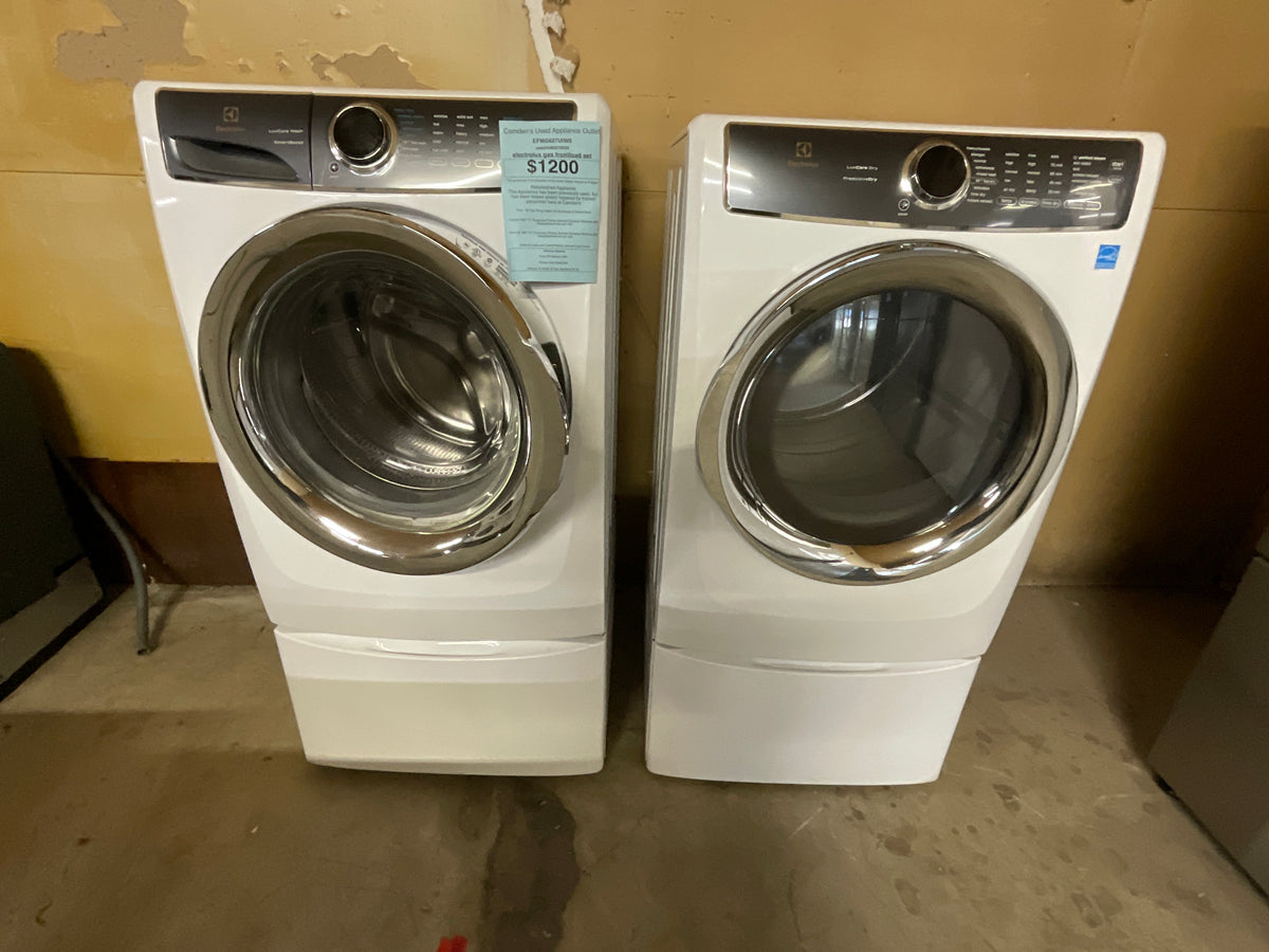 Electrolux Gas frontload washer dryer set on peds.
